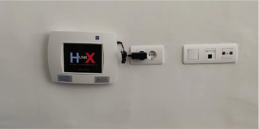 Dispositivo anticapilaridad Humix conectado a la corriente para eliminar humedad en paredes